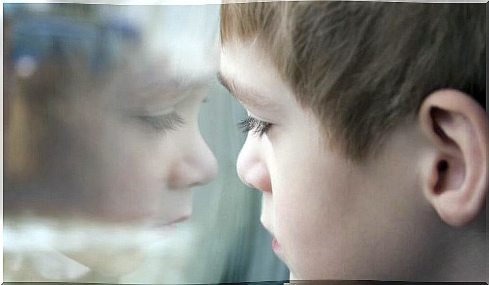 Child looking behind glass depicting future causes of exaggerated narcissism