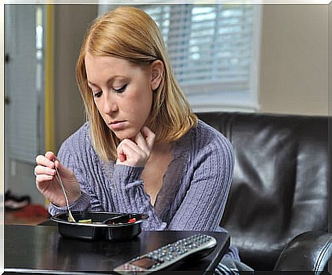 Sad woman having dinner