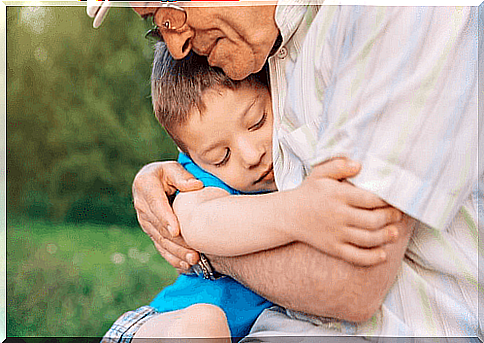 Boy getting hugs from his grandfather