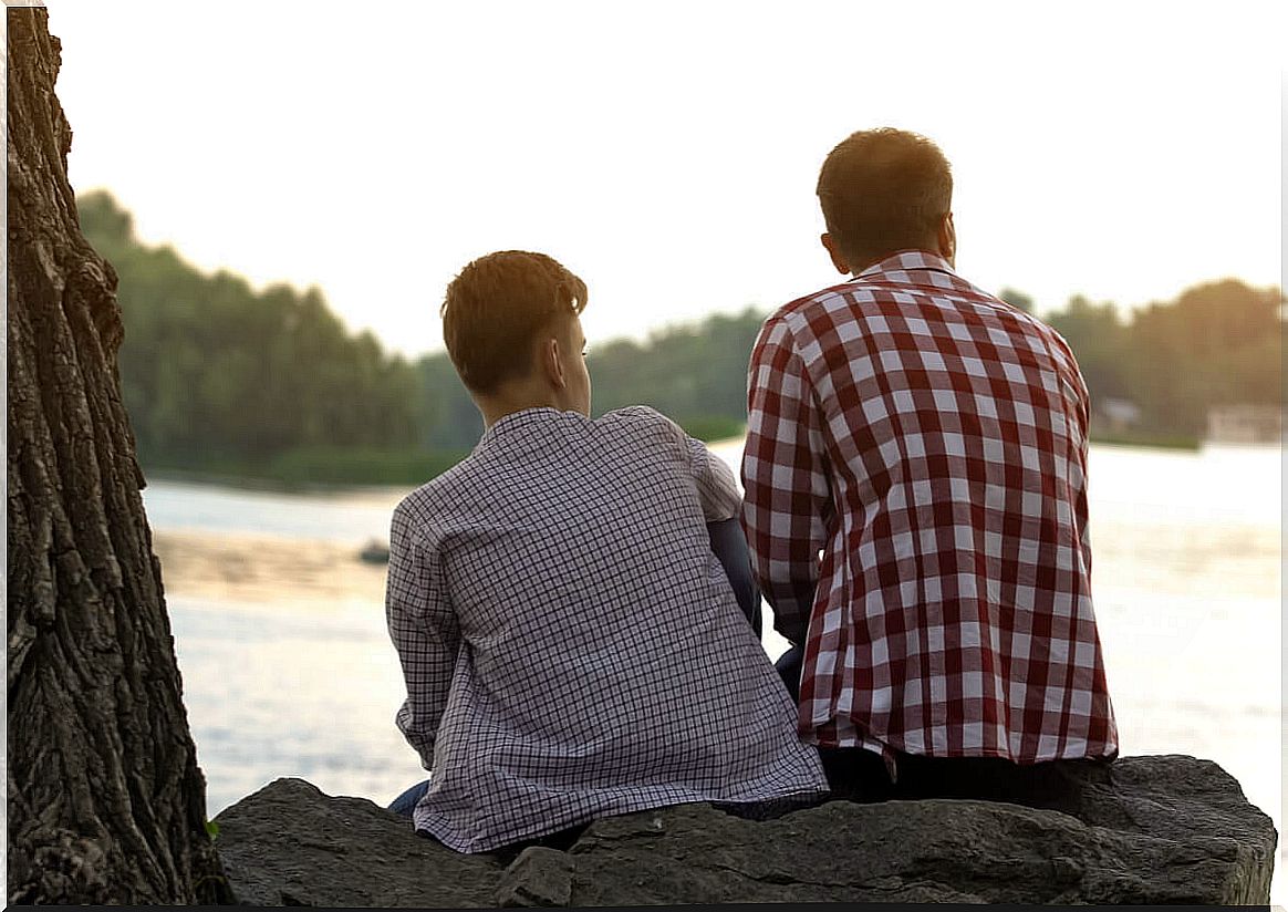 Father and teenage son with their backs turned