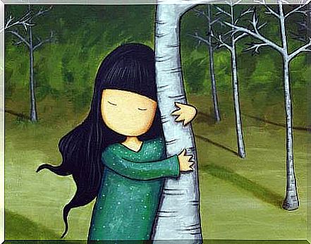 Girl hugging a tree trunk symbolizing happy people