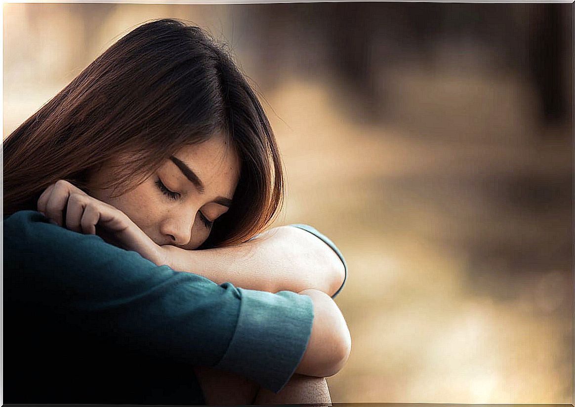 Sad woman sitting thinking about the loss of a loved one