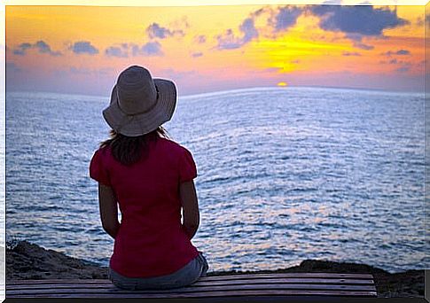 Woman afraid of dying thinking in front of the sea