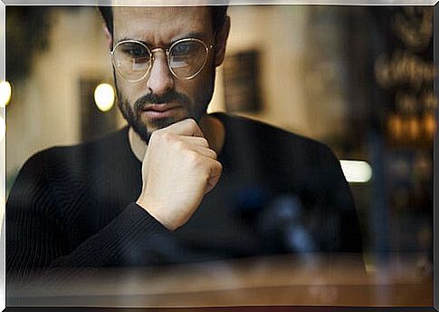 Man with glasses thinking