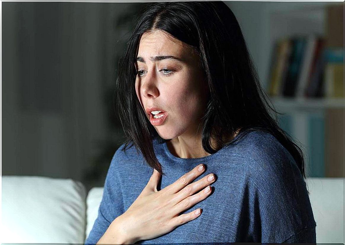 Woman with hand on chest