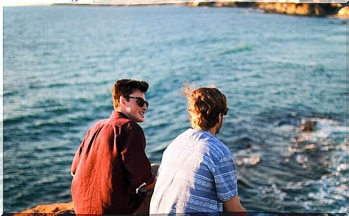 Travel friends looking at the sea