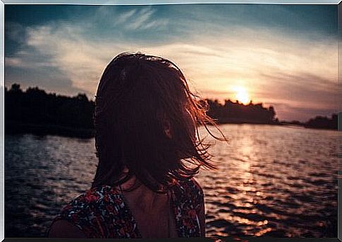 Woman looking out to sea thanking