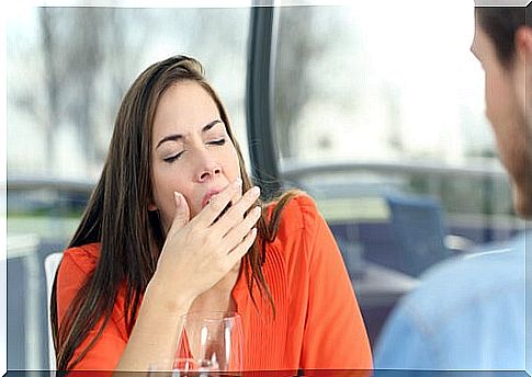 Woman yawning while talking to her partner