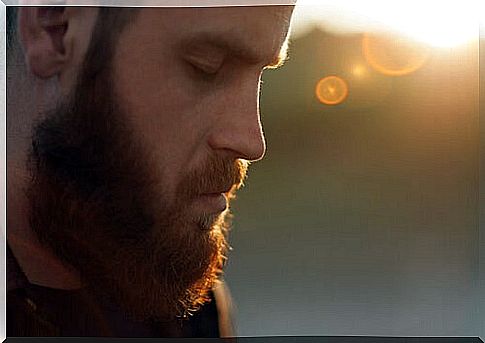 Bearded man looking down