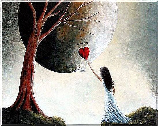 Girl catching a heart hanging from a tree