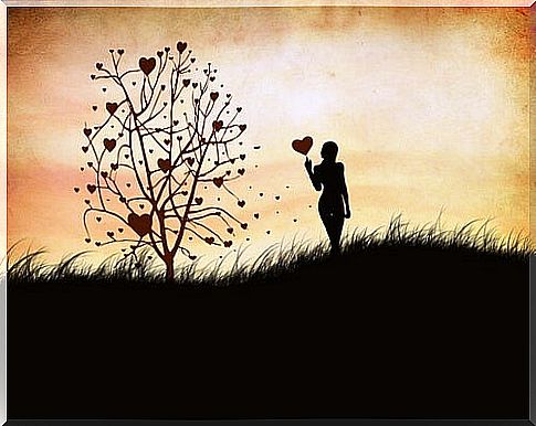 Woman with heart balloon in her hand next to the tree of feelings